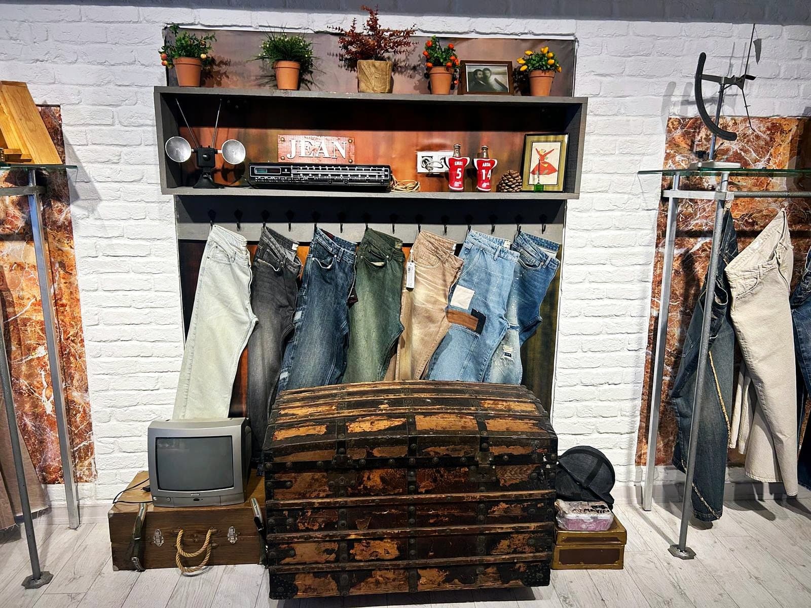 Jeans across a range of wash shades in the vintage corner of Rinato's showroom